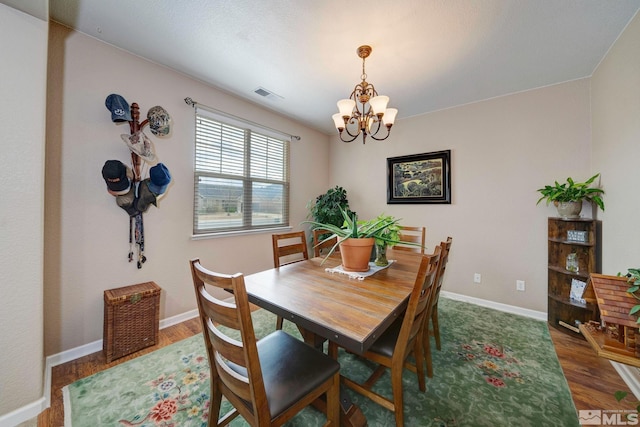 166 Oakridge Dr, Dayton, NV 89403 - dining space featuring a chandelier, wood finished floors, and baseboards