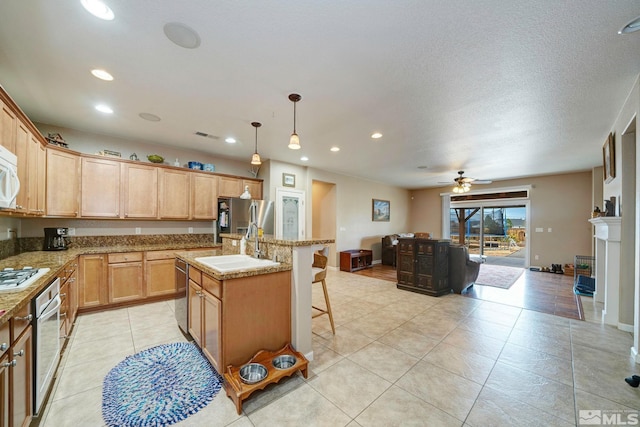 166 Oakridge Dr, Dayton, NV 89403 - kitchen featuring appliances with stainless steel finishes, recessed lighting, a sink, a center island with sink, and a kitchen breakfast bar