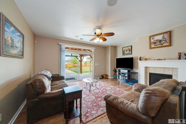 166 Oakridge Dr, Dayton, NV 89403 - living room featuring wood finished floors, a ceiling fan, a fireplace, and baseboards