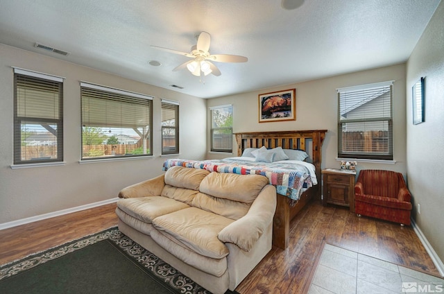 166 Oakridge Dr, Dayton, NV 89403 - bedroom featuring multiple windows, wood finished floors, baseboards, and a ceiling fan