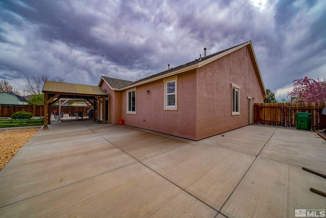 166 Oakridge Dr, Dayton, NV 89403 - view of front of house featuring a gazebo, a patio area, a fenced backyard, stucco siding, and concrete driveway