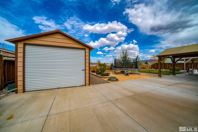 166 Oakridge Dr, Dayton, NV 89403 - detached garage with a trampoline and fence
