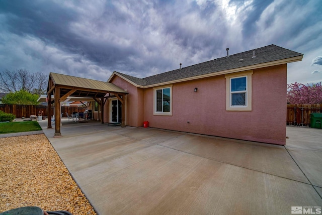 166 Oakridge Dr, Dayton, NV 89403 - back of property featuring a gazebo, fence, stucco siding, and a patio area