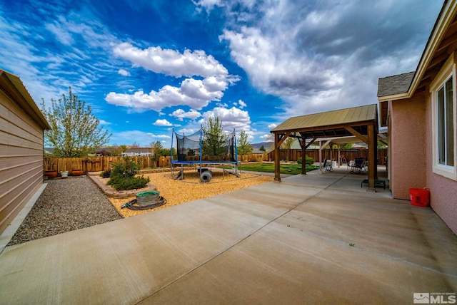 166 Oakridge Dr, Dayton, NV 89403 - view of patio with a trampoline, a gazebo, and a fenced backyard