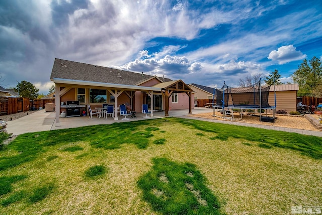 166 Oakridge Dr, Dayton, NV 89403 - rear view of property featuring a trampoline and a patio area