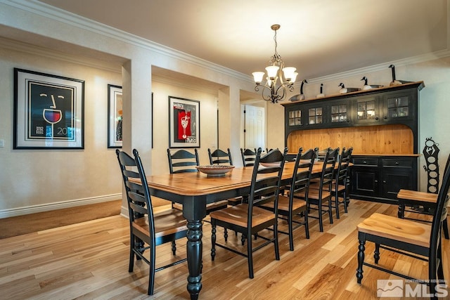 2143 The Back Rd, Glenbrook, NV 89413 - dining space with a chandelier, light wood finished floors, baseboards, and crown molding