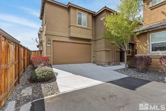 6742 Peppergrass Dr, Sparks, NV 89436 - view of front of home with an attached garage, stucco siding, fence, and concrete driveway