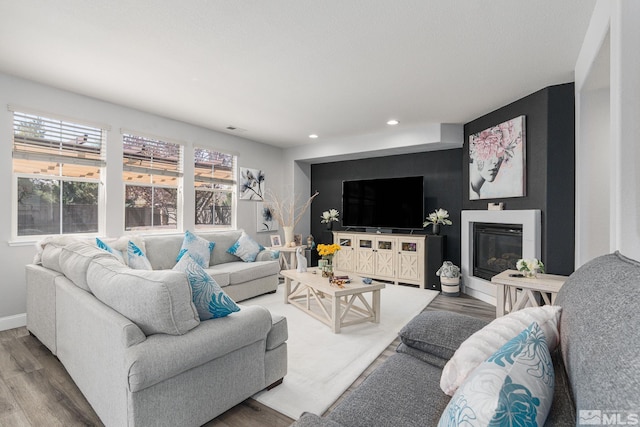 450 Ruffian Ct, Reno, NV 89521 - living area with wood finished floors, recessed lighting, a glass covered fireplace, and baseboards