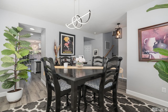 450 Ruffian Ct, Reno, NV 89521 - dining space with a chandelier, baseboards, and wood finished floors