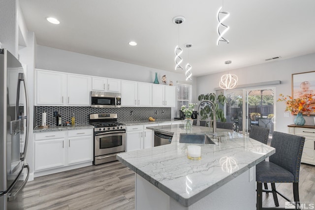 450 Ruffian Ct, Reno, NV 89521 - kitchen with stainless steel appliances, a sink, backsplash, light wood-type flooring, and recessed lighting