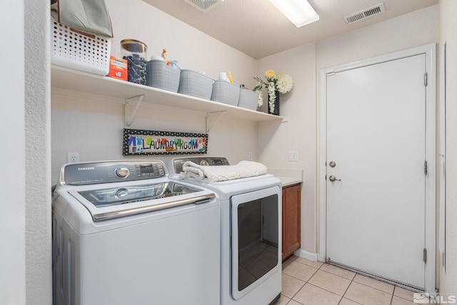 450 Ruffian Ct, Reno, NV 89521 - laundry area featuring cabinet space, washing machine and dryer, and light tile patterned flooring