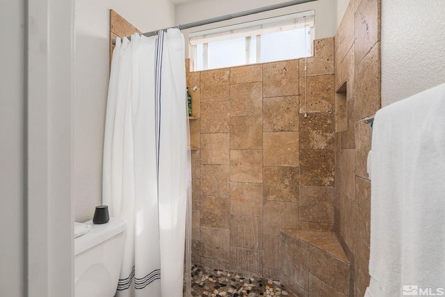 450 Ruffian Ct, Reno, NV 89521 - full bathroom with tiled shower, stone tile flooring, and toilet