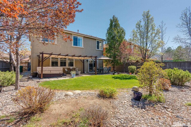 450 Ruffian Ct, Reno, NV 89521 - back of property with a hot tub, a pergola, a patio area, and stucco siding