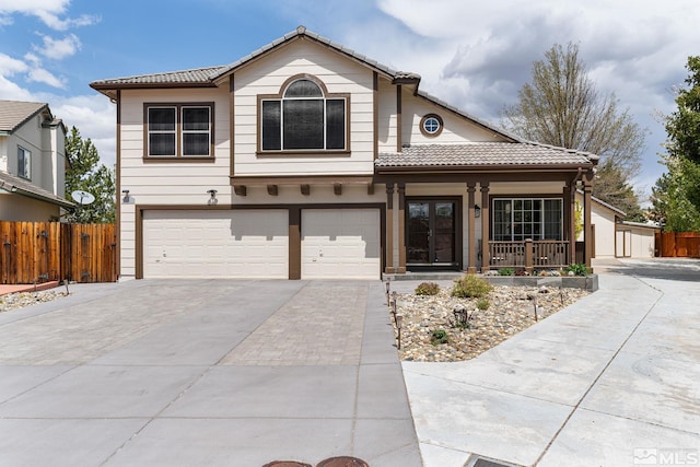 2116 Frisco Way, Sparks, NV 89434 - view of front facade with a porch, fence, concrete driveway, a tiled roof, and an attached garage