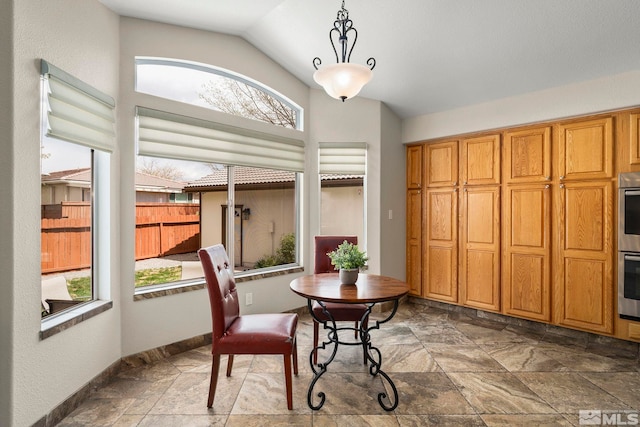 2116 Frisco Way, Sparks, NV 89434 - dining space with healthy amount of natural light, stone tile flooring, lofted ceiling, and baseboards