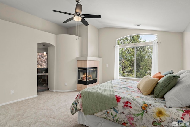 2116 Frisco Way, Sparks, NV 89434 - carpeted bedroom featuring arched walkways, vaulted ceiling, a fireplace, ceiling fan, and baseboards