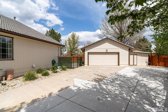 2116 Frisco Way, Sparks, NV 89434 - view of side of home with a tiled roof, fence, driveway, and an attached garage
