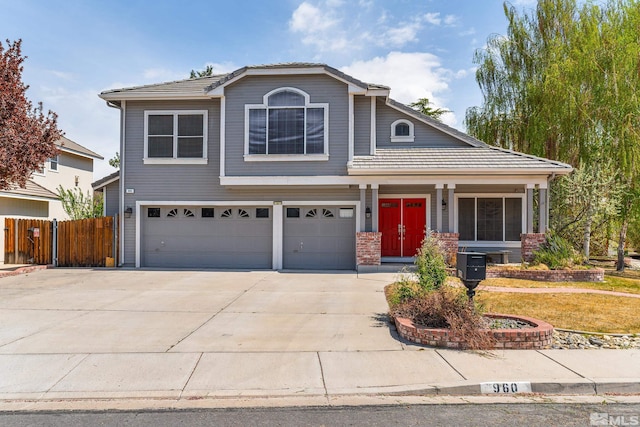960 Country Ridge Dr, Sparks, NV 89434 - traditional-style home with a garage, driveway, fence, and covered porch
