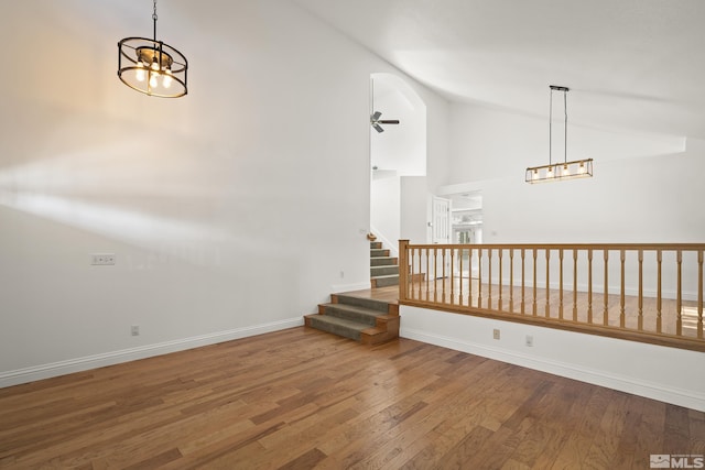 960 Country Ridge Dr, Sparks, NV 89434 - spare room featuring wood finished floors, a chandelier, high vaulted ceiling, baseboards, and stairs