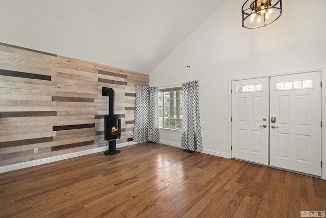 960 Country Ridge Dr, Sparks, NV 89434 - foyer entrance featuring high vaulted ceiling, a wood stove, wood finished floors, a chandelier, and baseboards