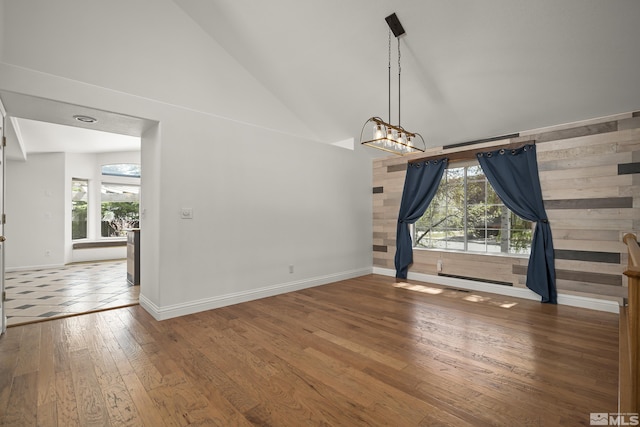 960 Country Ridge Dr, Sparks, NV 89434 - unfurnished dining area with high vaulted ceiling, wood-type flooring, plenty of natural light, baseboards, and a chandelier