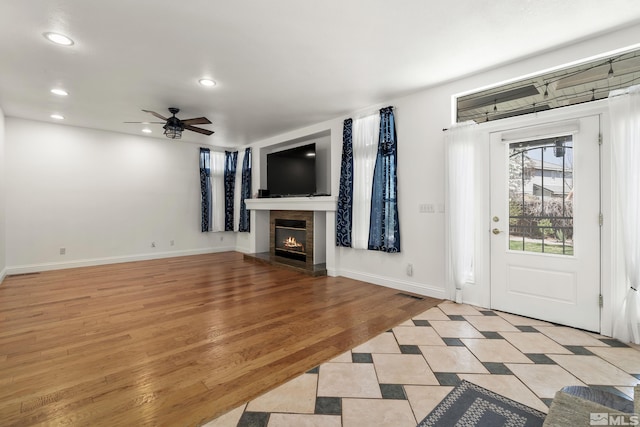 960 Country Ridge Dr, Sparks, NV 89434 - unfurnished living room with ceiling fan, recessed lighting, a glass covered fireplace, baseboards, and light wood-style floors