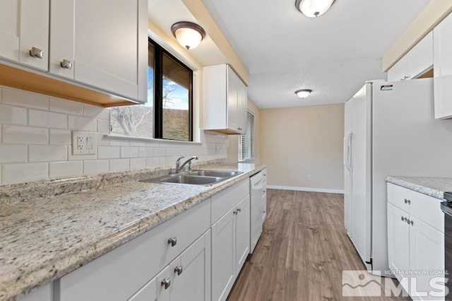 68 Zircon Dr, Reno, NV 89521 - kitchen with white appliances, a sink, white cabinetry, and decorative backsplash