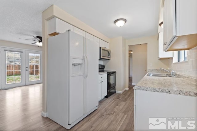68 Zircon Dr, Reno, NV 89521 - kitchen with stainless steel microwave, white fridge with ice dispenser, black range with electric stovetop, a sink, and ceiling fan