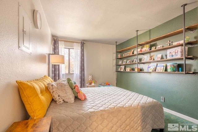 2700 Plumas St Unit 300, Reno, NV 89509 - bedroom with baseboards, a textured wall, and carpet flooring