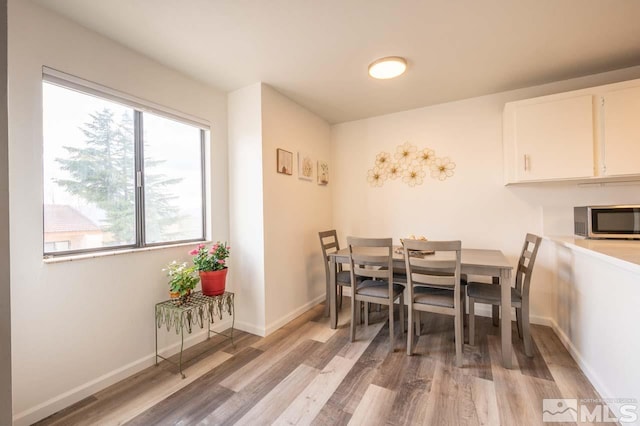 2700 Plumas St Unit 300, Reno, NV 89509 - dining area featuring light wood-style floors and baseboards