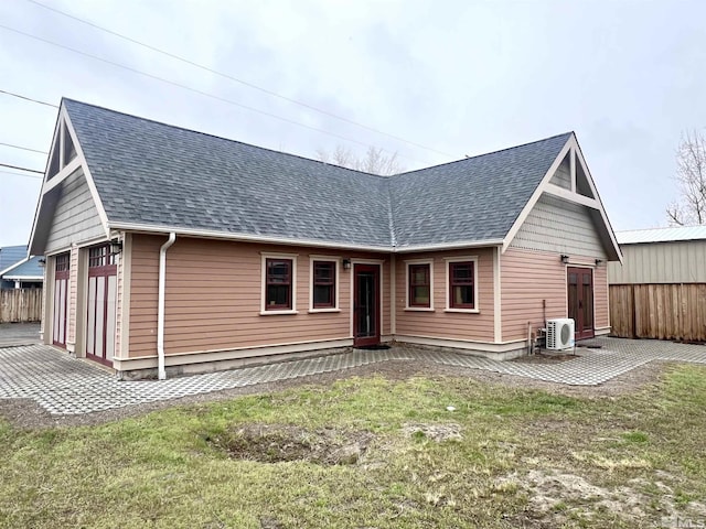 215 S Broad St, Battle Mountain, NV 89820 - back of house featuring roof with shingles, ac unit, fence, and a detached garage