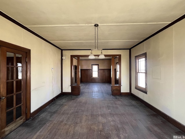 215 S Broad St, Battle Mountain, NV 89820 - unfurnished dining area with dark wood-style flooring, ornamental molding, and baseboards