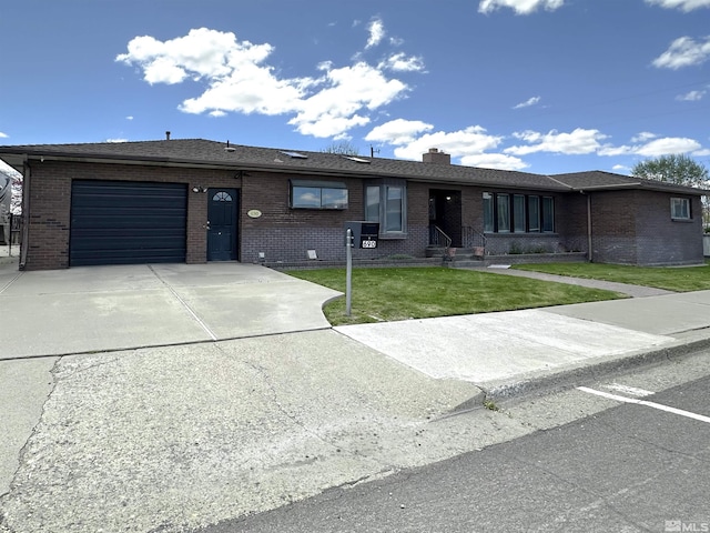 ranch-style house with brick siding, a garage, concrete driveway, and a front lawn