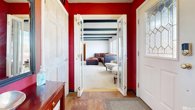 foyer featuring plenty of natural light and carpet floors
