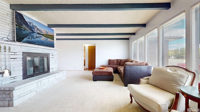 living area with beamed ceiling, carpet floors, and a stone fireplace