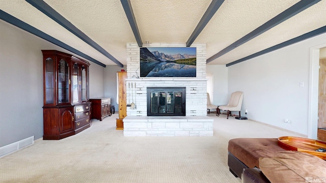 carpeted living room featuring a fireplace, beamed ceiling, a textured ceiling, and baseboards