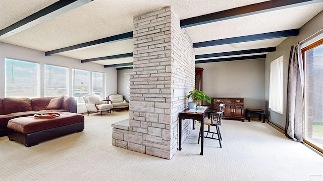carpeted living area with beamed ceiling, a textured ceiling, decorative columns, and plenty of natural light