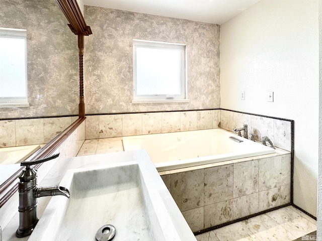 bathroom with healthy amount of natural light and a tub with jets