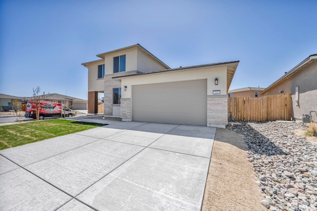 15 Nova Ct Unit 112, Carson City, NV 89705 - contemporary house featuring driveway, stucco siding, fence, an attached garage, and stone siding