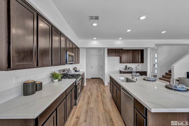 15 Nova Ct Unit 112, Carson City, NV 89705 - kitchen with a sink, appliances with stainless steel finishes, light wood-style flooring, recessed lighting, and dark brown cabinetry