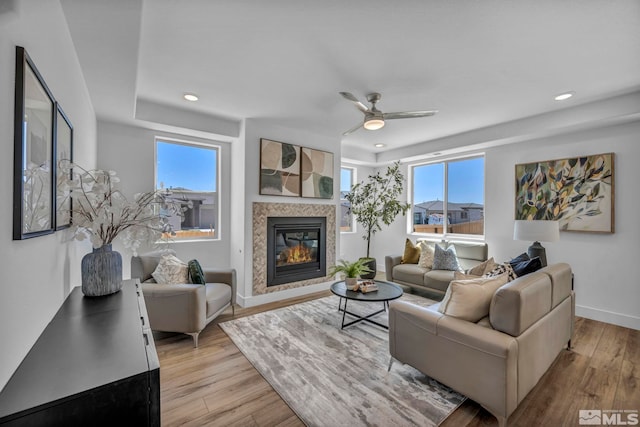 15 Nova Ct Unit 112, Carson City, NV 89705 - living area featuring light wood-type flooring, a glass covered fireplace, plenty of natural light, a ceiling fan, and recessed lighting