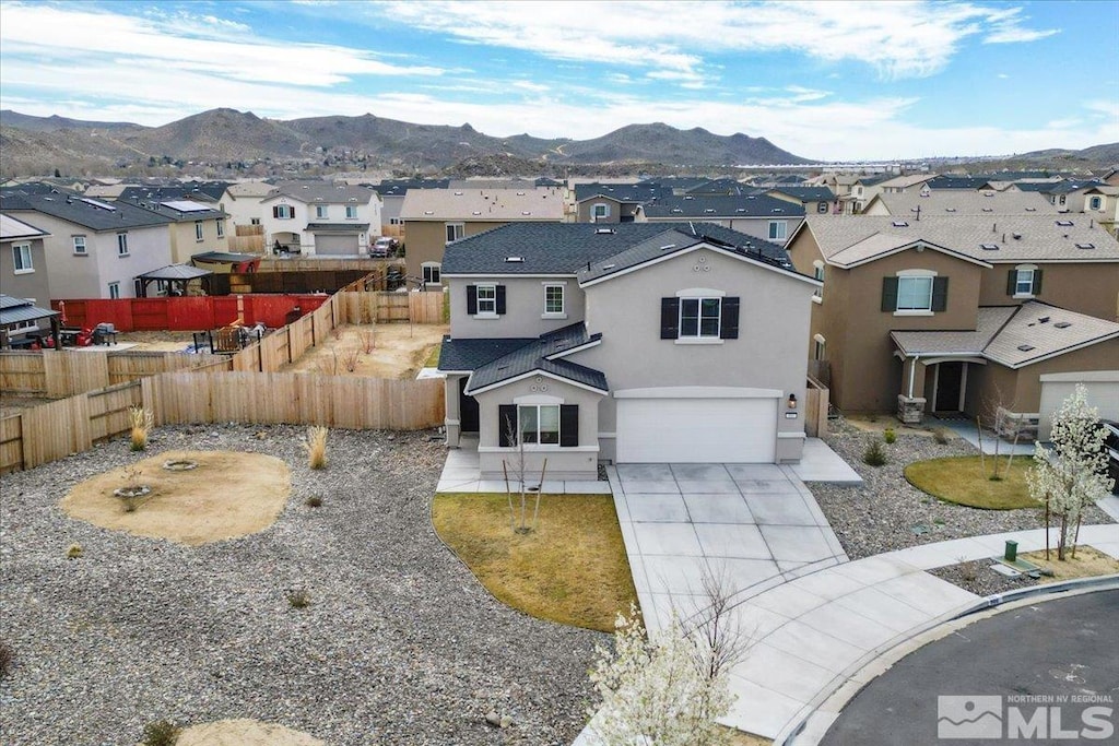 900 Convair Ct, Reno, NV 89506 - view of front facade featuring a residential view, stucco siding, a mountain view, and a garage