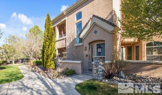 9900 Wilbur May Pkwy Unit 2704, Reno, NV 89521 - view of front of house with a gate, a fenced front yard, and stucco siding