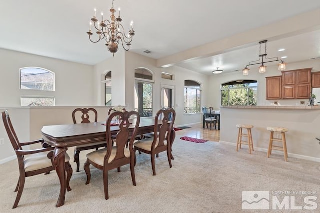 9900 Wilbur May Pkwy Unit 2704, Reno, NV 89521 - dining room with baseboards, a chandelier, and light colored carpet