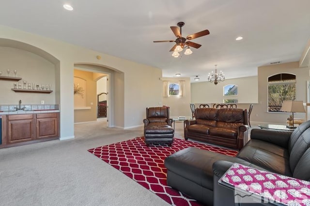 9900 Wilbur May Pkwy Unit 2704, Reno, NV 89521 - living room featuring a ceiling fan, light colored carpet, wet bar, baseboards, and a chandelier