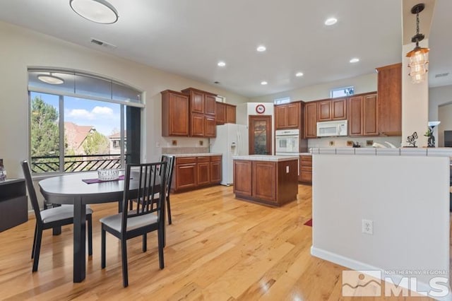 9900 Wilbur May Pkwy Unit 2704, Reno, NV 89521 - kitchen with white appliances, light countertops, a center island, plenty of natural light, and recessed lighting