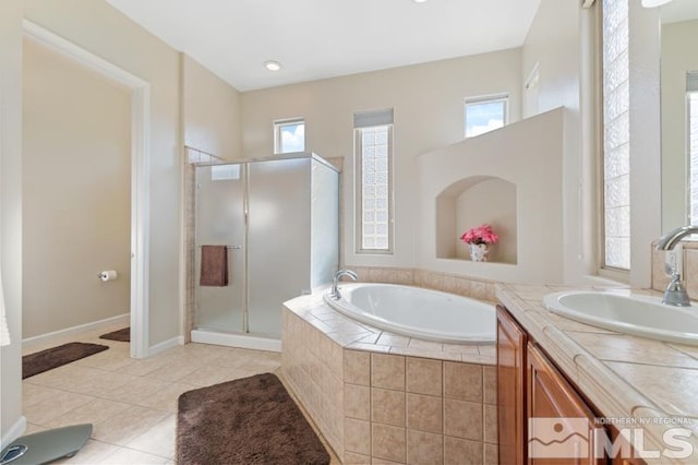 9900 Wilbur May Pkwy Unit 2704, Reno, NV 89521 - bathroom with tile patterned flooring, a bath, vanity, a stall shower, and baseboards