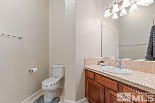 9900 Wilbur May Pkwy Unit 2704, Reno, NV 89521 - bathroom featuring toilet, vanity, and baseboards