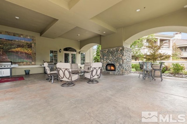 9900 Wilbur May Pkwy Unit 2704, Reno, NV 89521 - view of patio featuring an outdoor stone fireplace and area for grilling