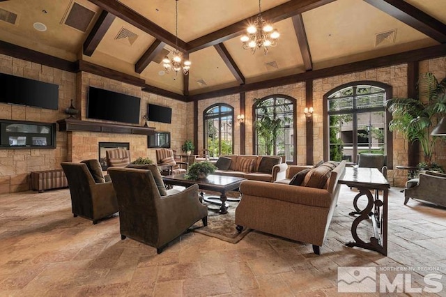9900 Wilbur May Pkwy Unit 2704, Reno, NV 89521 - living area featuring stone tile flooring, high vaulted ceiling, beam ceiling, a chandelier, and exterior fireplace